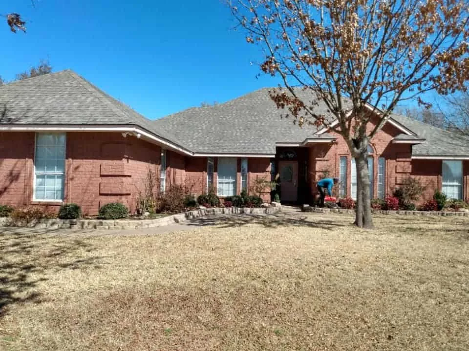 Ranch-style brick home with a completed gray roof