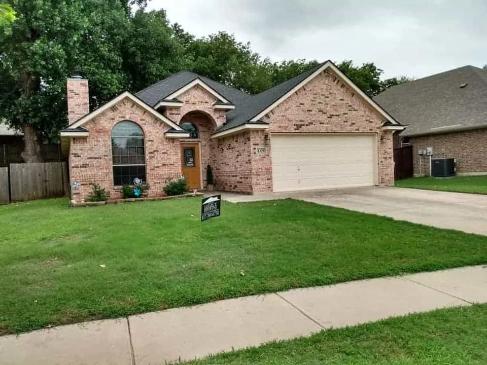 Single-story brick home with a new charcoal shingle roof