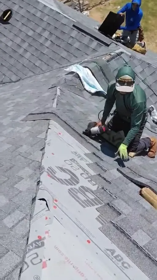 Roofing crew installing materials on a residential roof